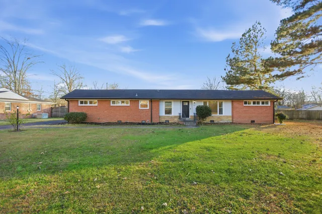 a view of a big yard with a house in the background