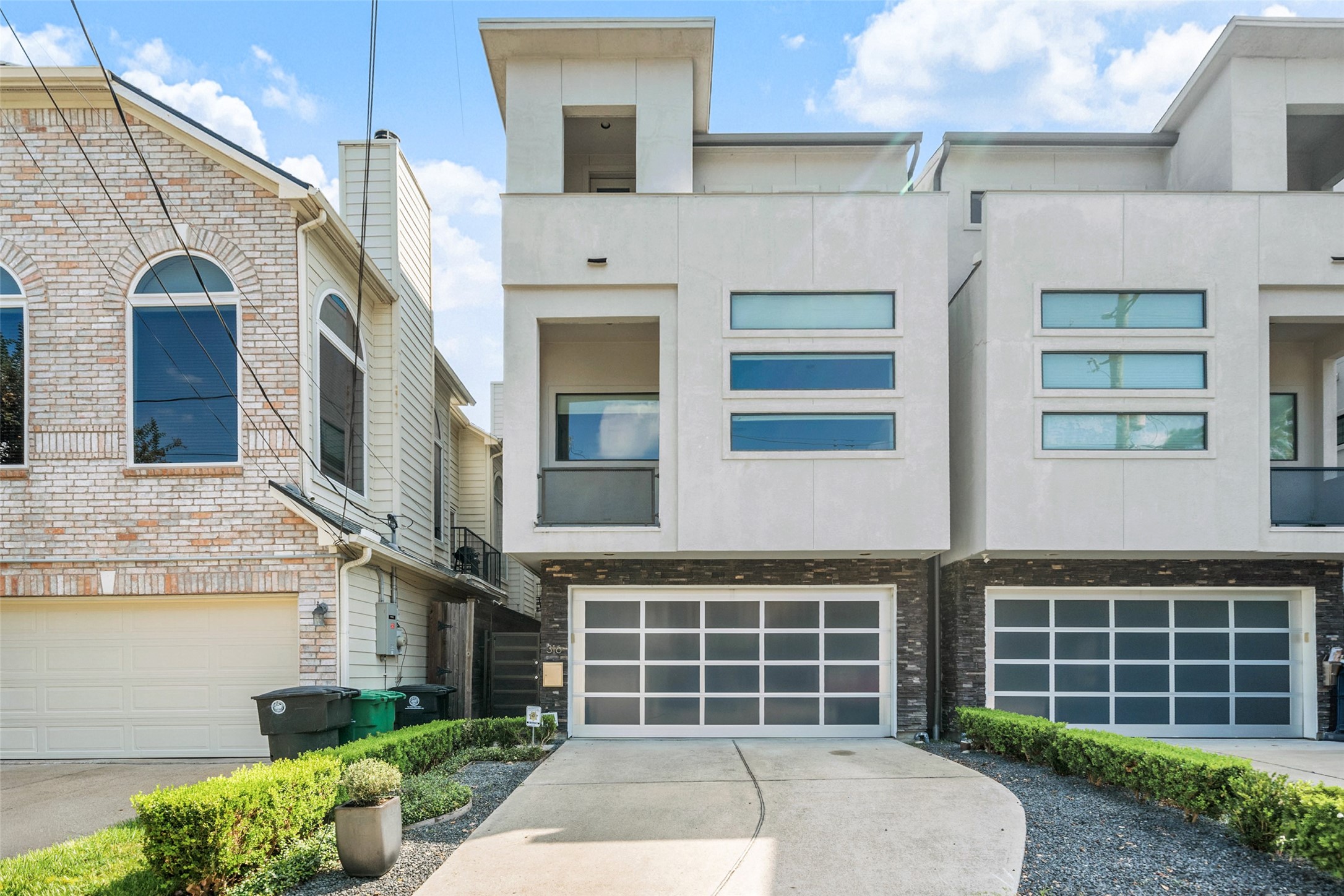 a front view of a house with large windows