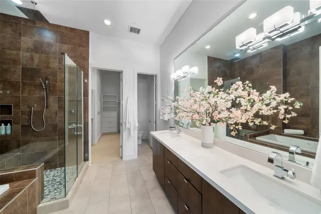 a bathroom with a sink mirror and shower