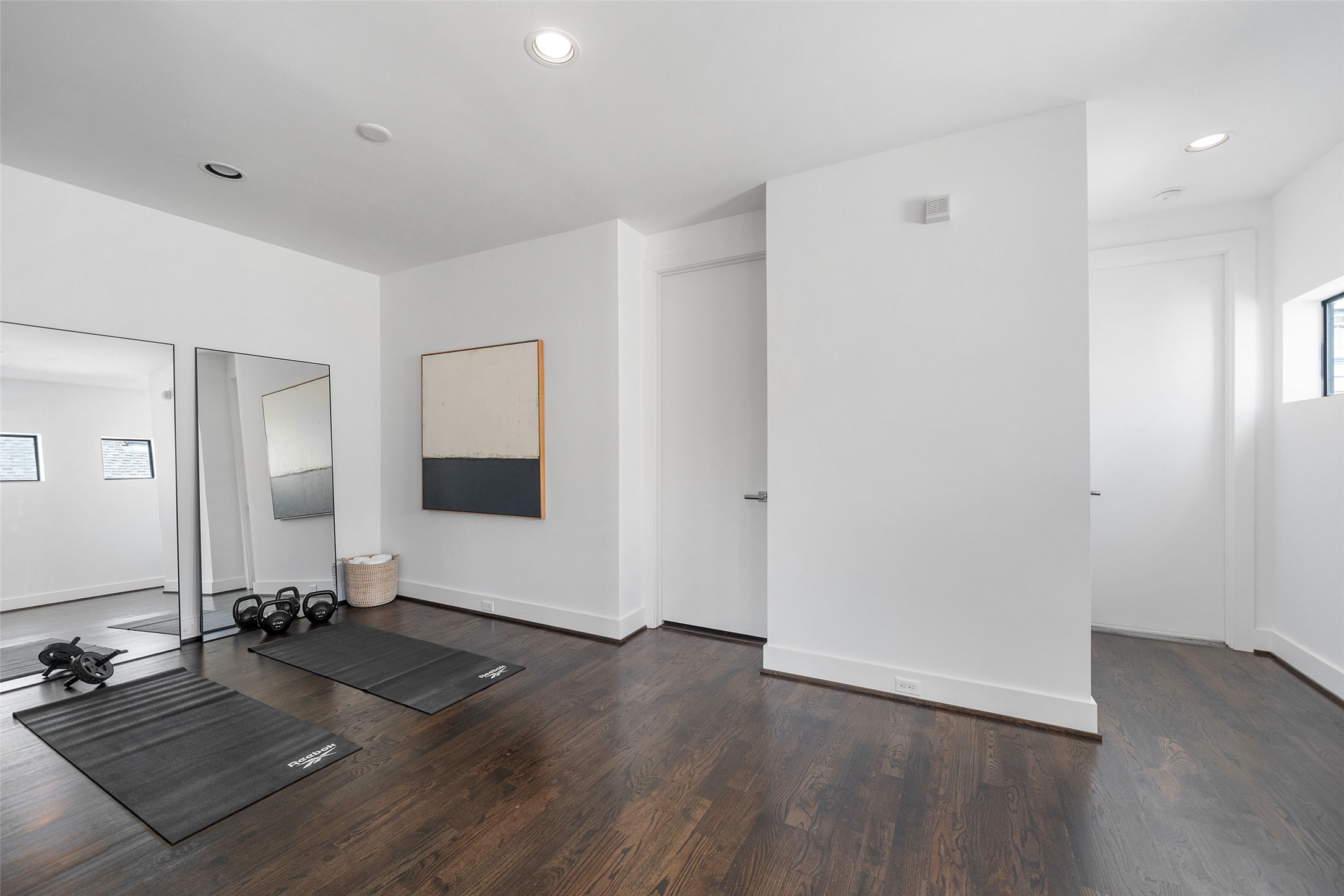 316 Birdsall Street Houston, TX 77007 - Photo 26 of 30 a living room with hard wood floors and gym equipment