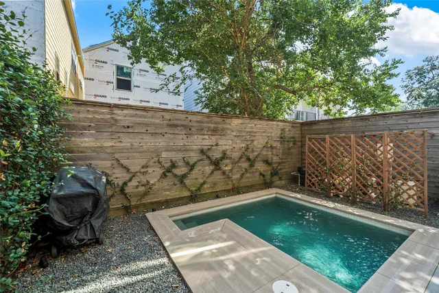 a view of a small pool in the backyard