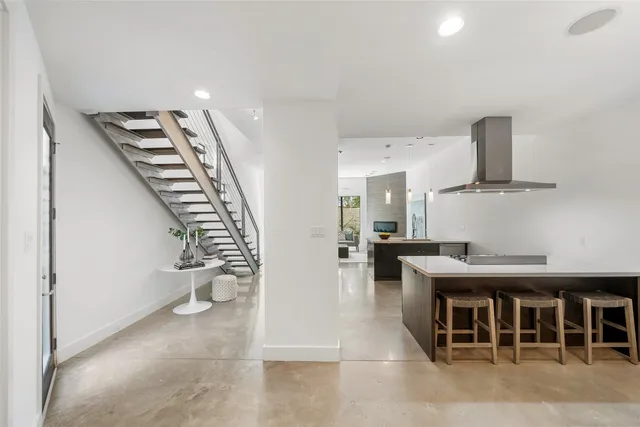 a view of a kitchen with furniture and an empty room