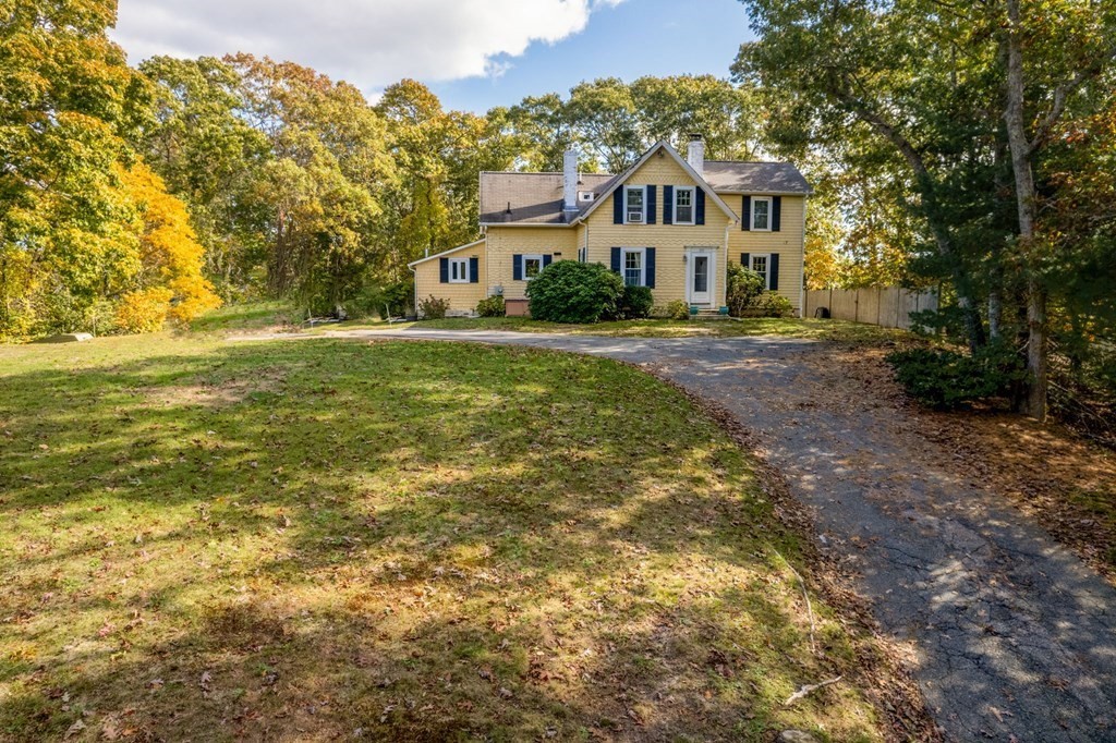 775 Shore Road Bourne, MA 02559 - Photo 1 of 42 a front view of a house with a yard