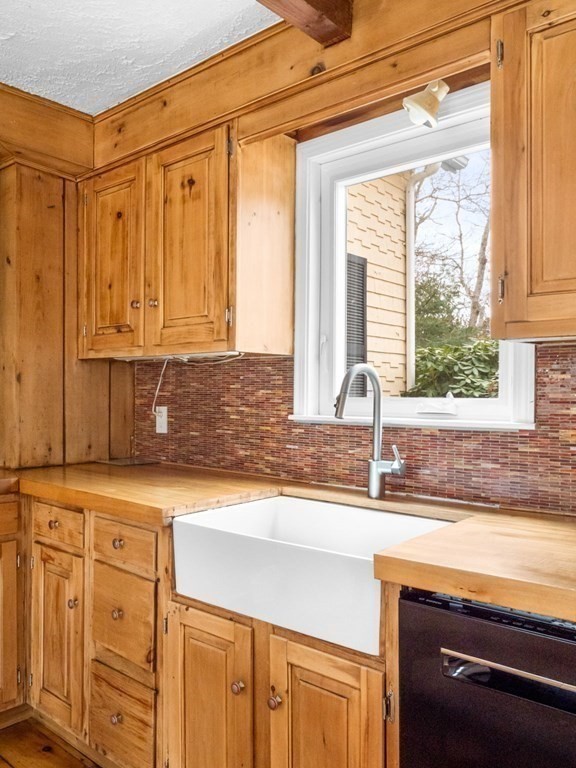 775 Shore Road Bourne, MA 02559 - Photo 11 of 42 a kitchen with stainless steel appliances granite countertop a sink and a window