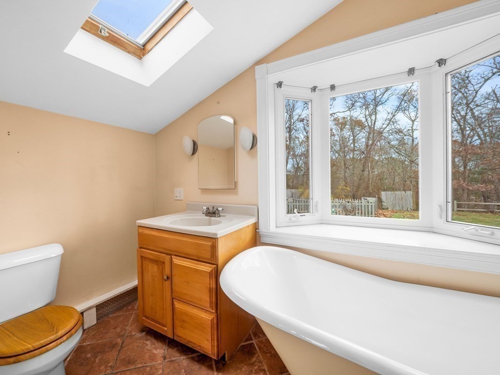 775 Shore Road Bourne, MA 02559 - Photo 17 of 42 a bathroom with a sink a toilet and a bathtub