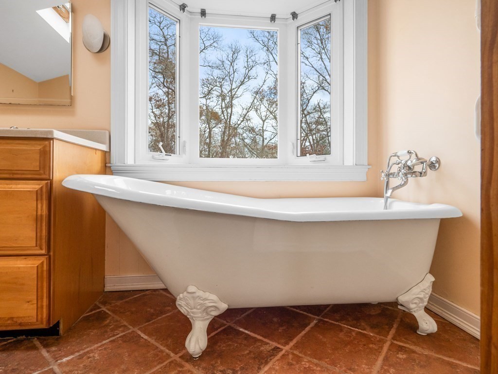775 Shore Road Bourne, MA 02559 - Photo 18 of 42 a bathroom with a sink and a mirror