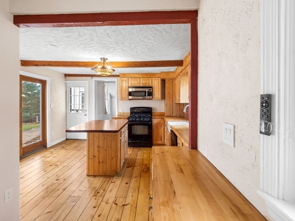 775 Shore Road Bourne, MA 02559 - Photo 19 of 42 a kitchen with a sink and wooden floor