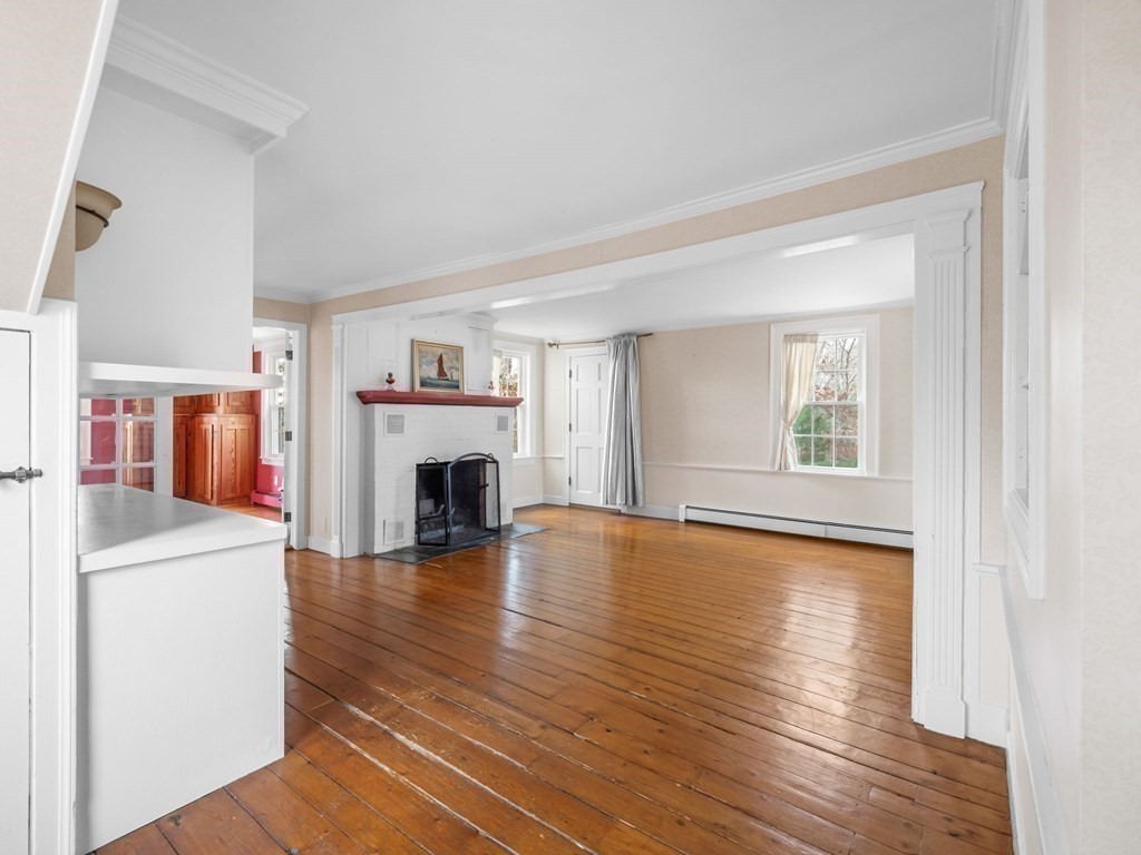 775 Shore Road Bourne, MA 02559 - Photo 20 of 42 a view of a livingroom with wooden floor and a fireplace