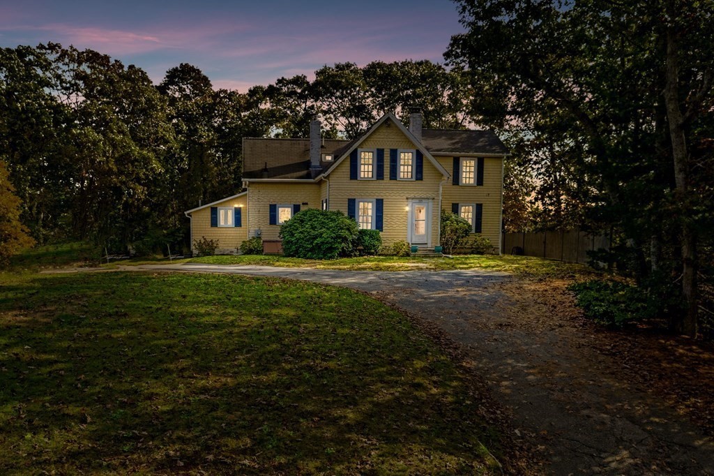 775 Shore Road Bourne, MA 02559 - Photo 2 of 42 a front view of a house with a yard