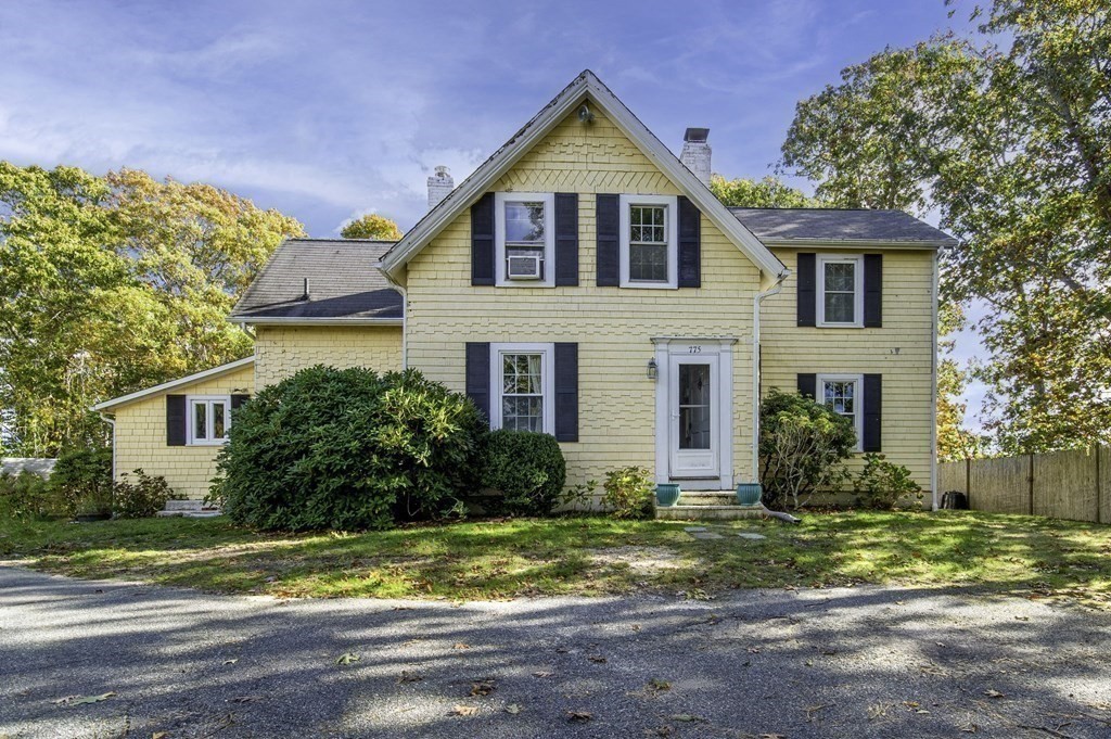 775 Shore Road Bourne, MA 02559 - Photo 3 of 42 a front view of house with yard and trees around