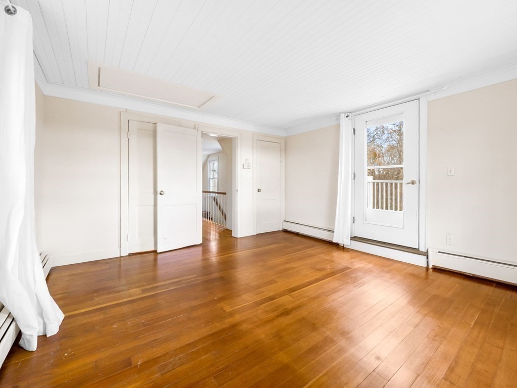 775 Shore Road Bourne, MA 02559 - Photo 38 of 42 a view of empty room with wooden floor and window