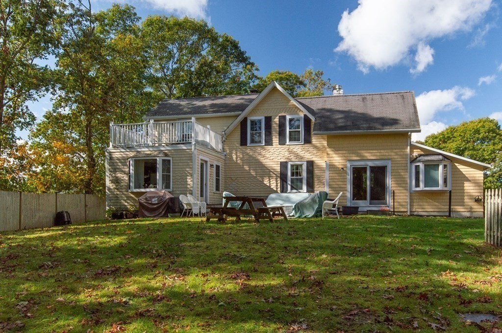 775 Shore Road Bourne, MA 02559 - Photo 4 of 42 a front view of a house with a yard