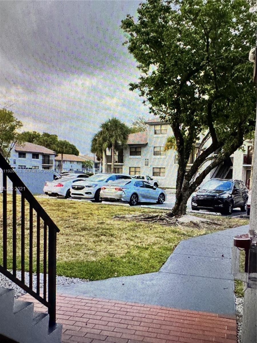 7130 Northwest 179th Street, Unit 108 Hialeah, FL 33015 - Photo 2 of 11 a view of a swimming pool with a patio