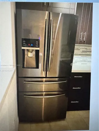 a close view of a refrigerator and a dishwasher in a kitchen