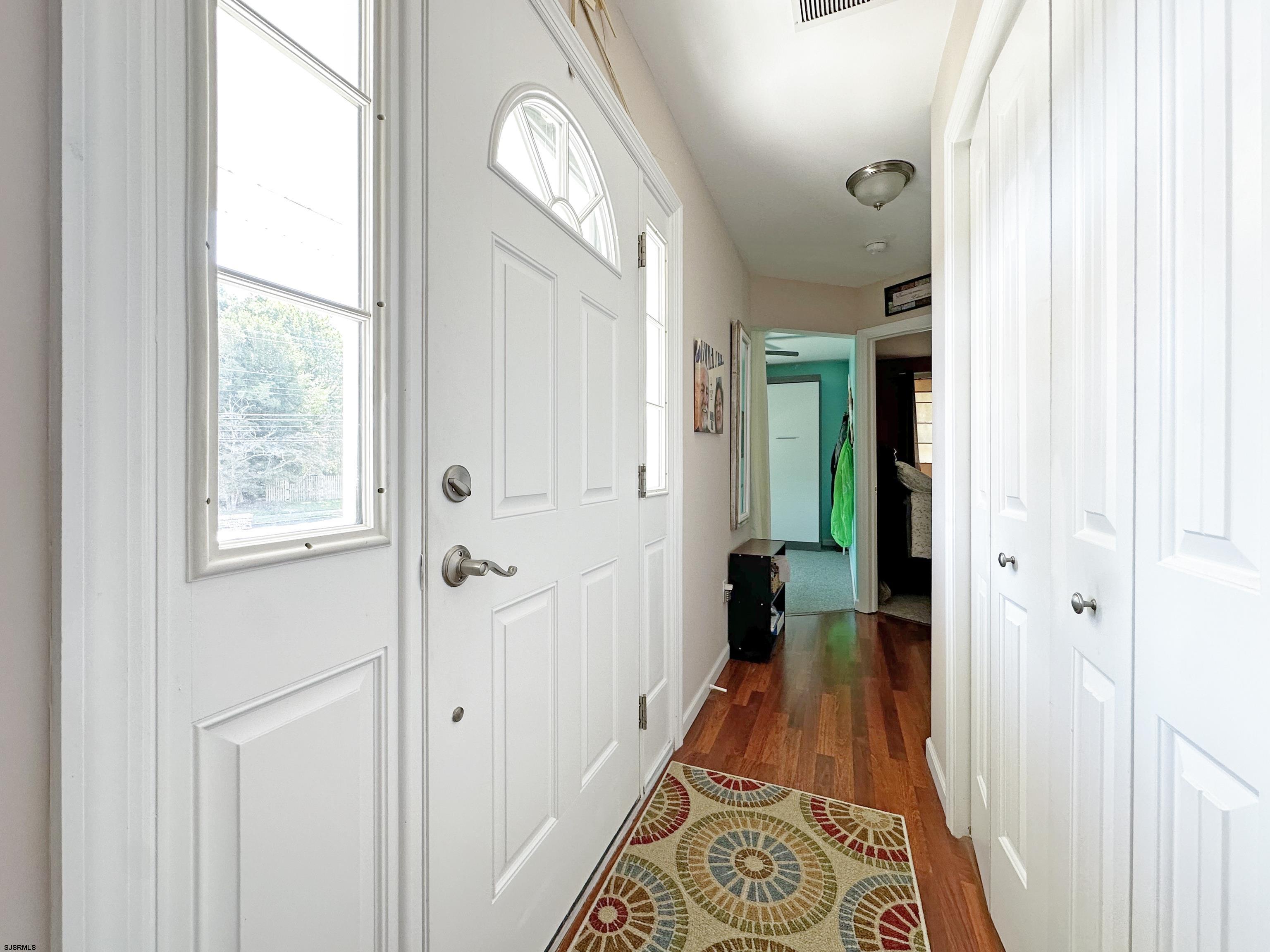 34 North Shore Road Marmora, NJ 08223 - Photo 11 of 37 a view of a hallway with wooden floor and a chandelier
