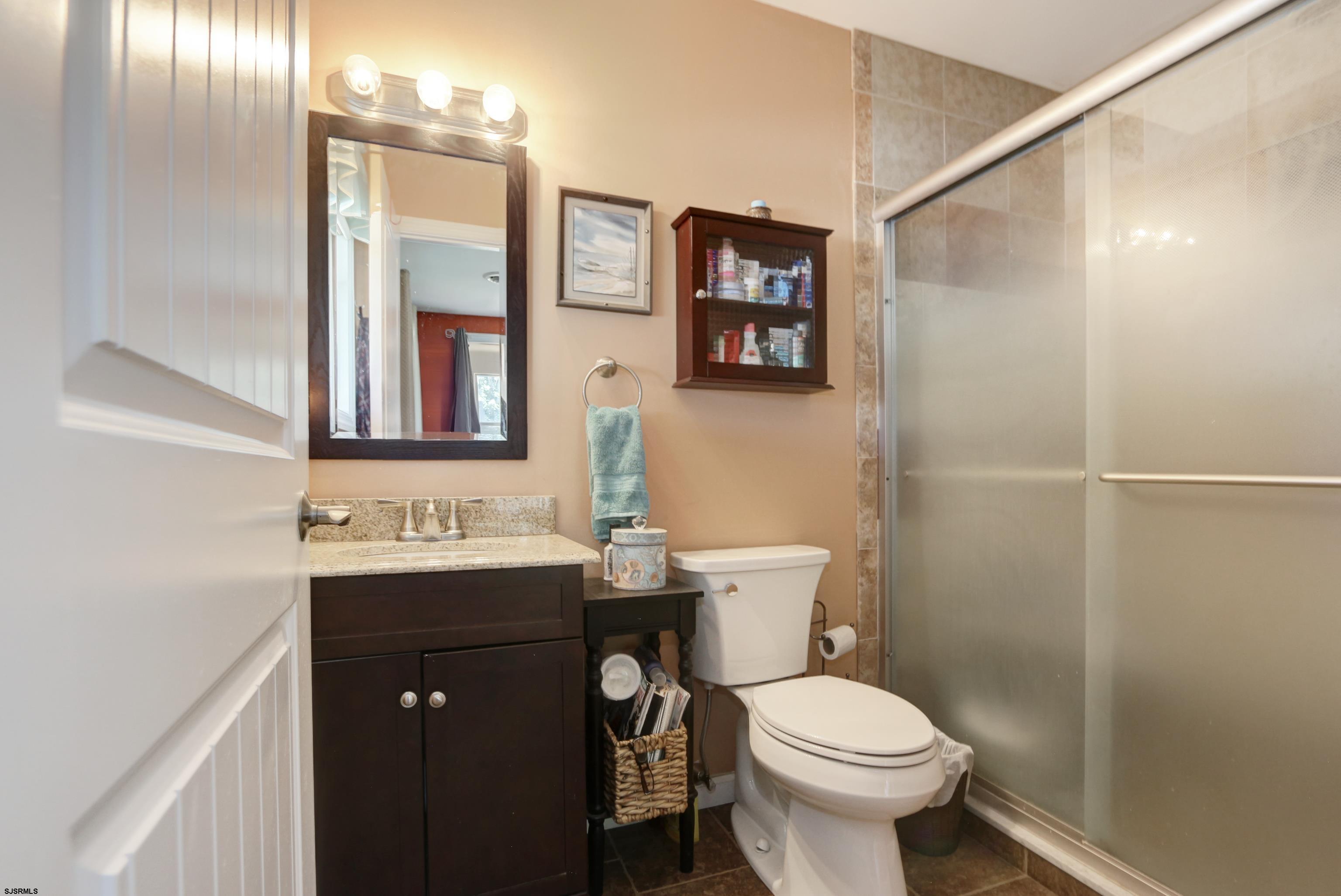 34 North Shore Road Marmora, NJ 08223 - Photo 15 of 37 a bathroom with a toilet sink and mirror