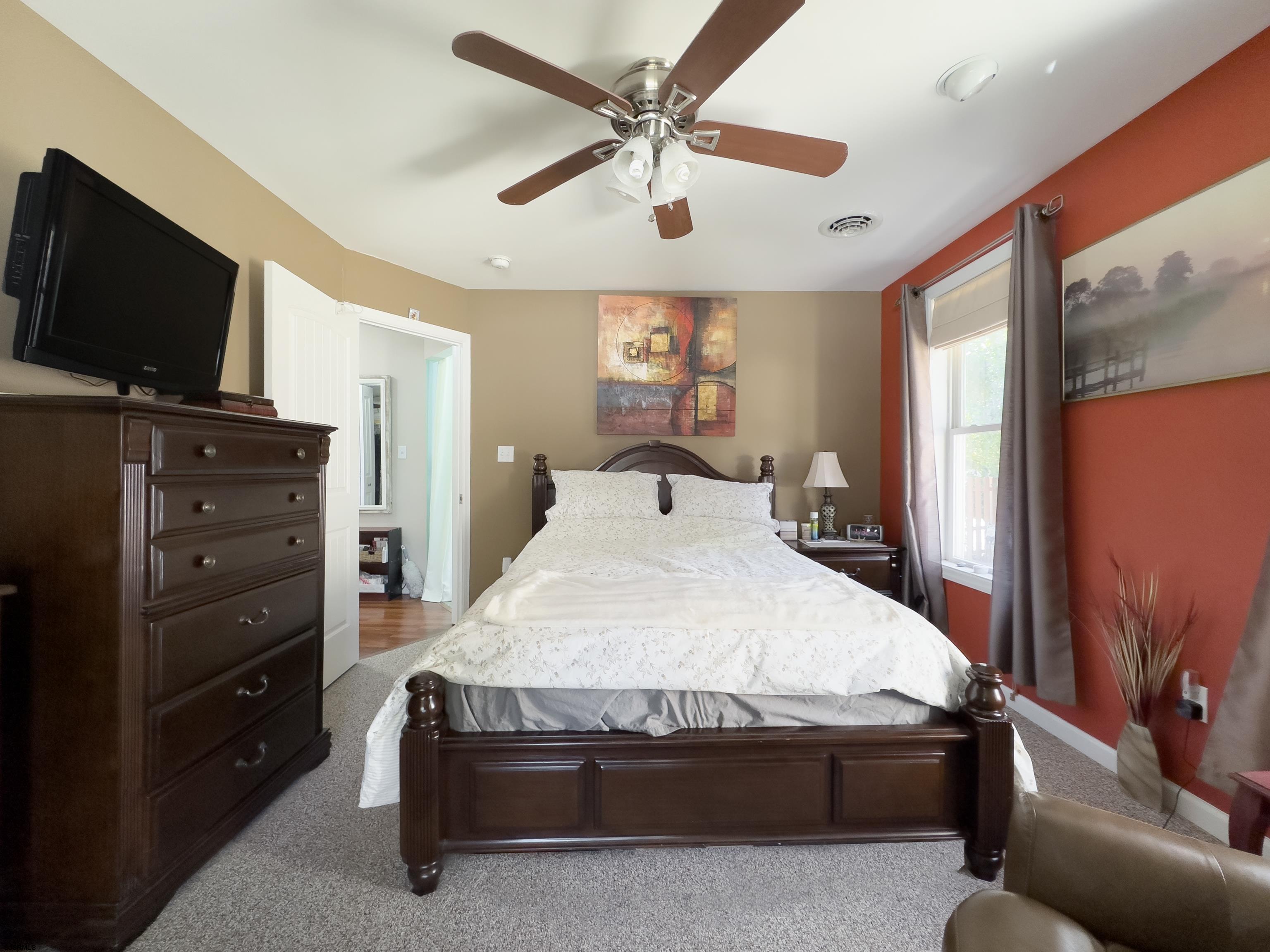 34 North Shore Road Marmora, NJ 08223 - Photo 19 of 37 a bed room with a bed window and a flat screen tv