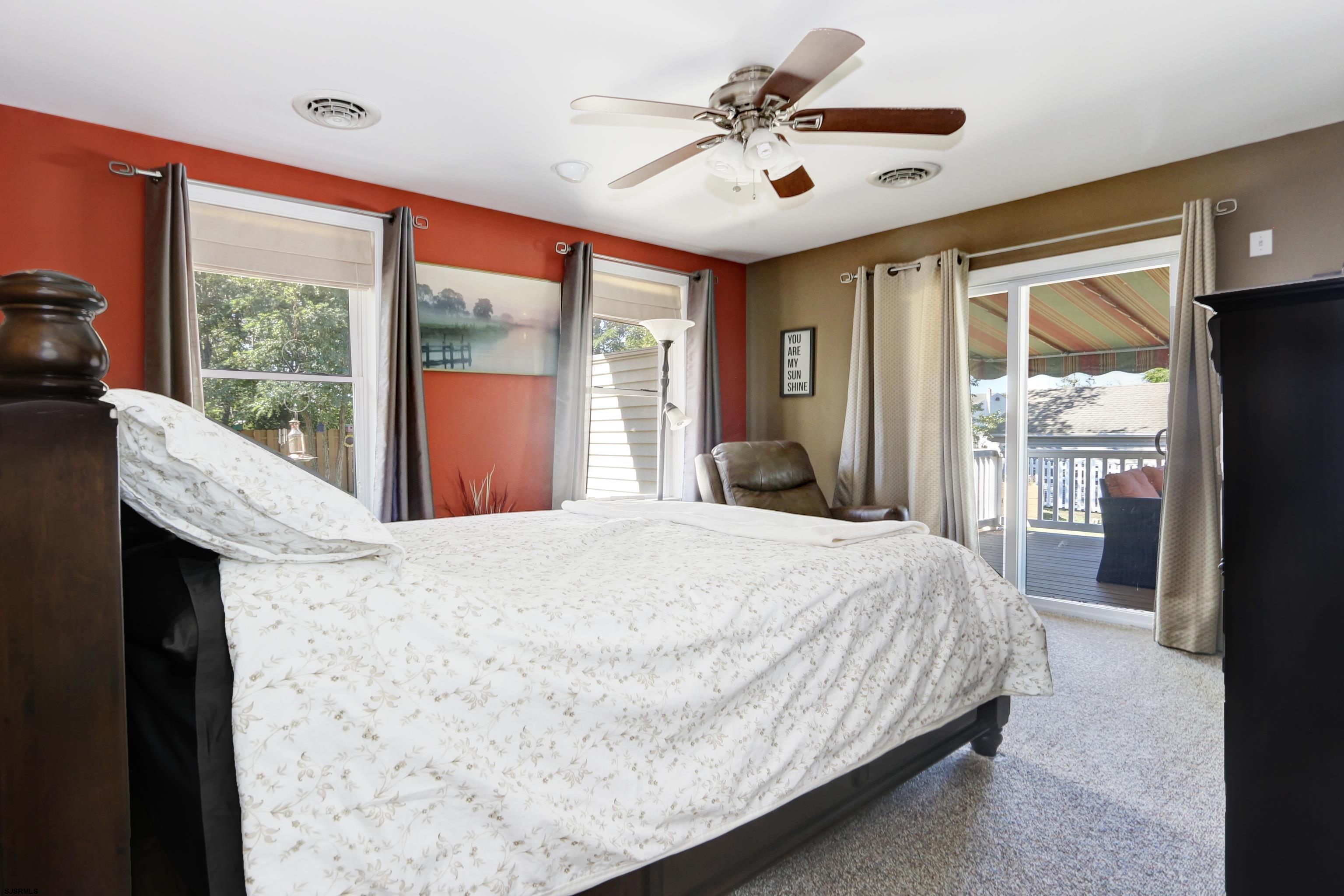 34 North Shore Road Marmora, NJ 08223 - Photo 21 of 37 a bedroom with a large bed and a large window