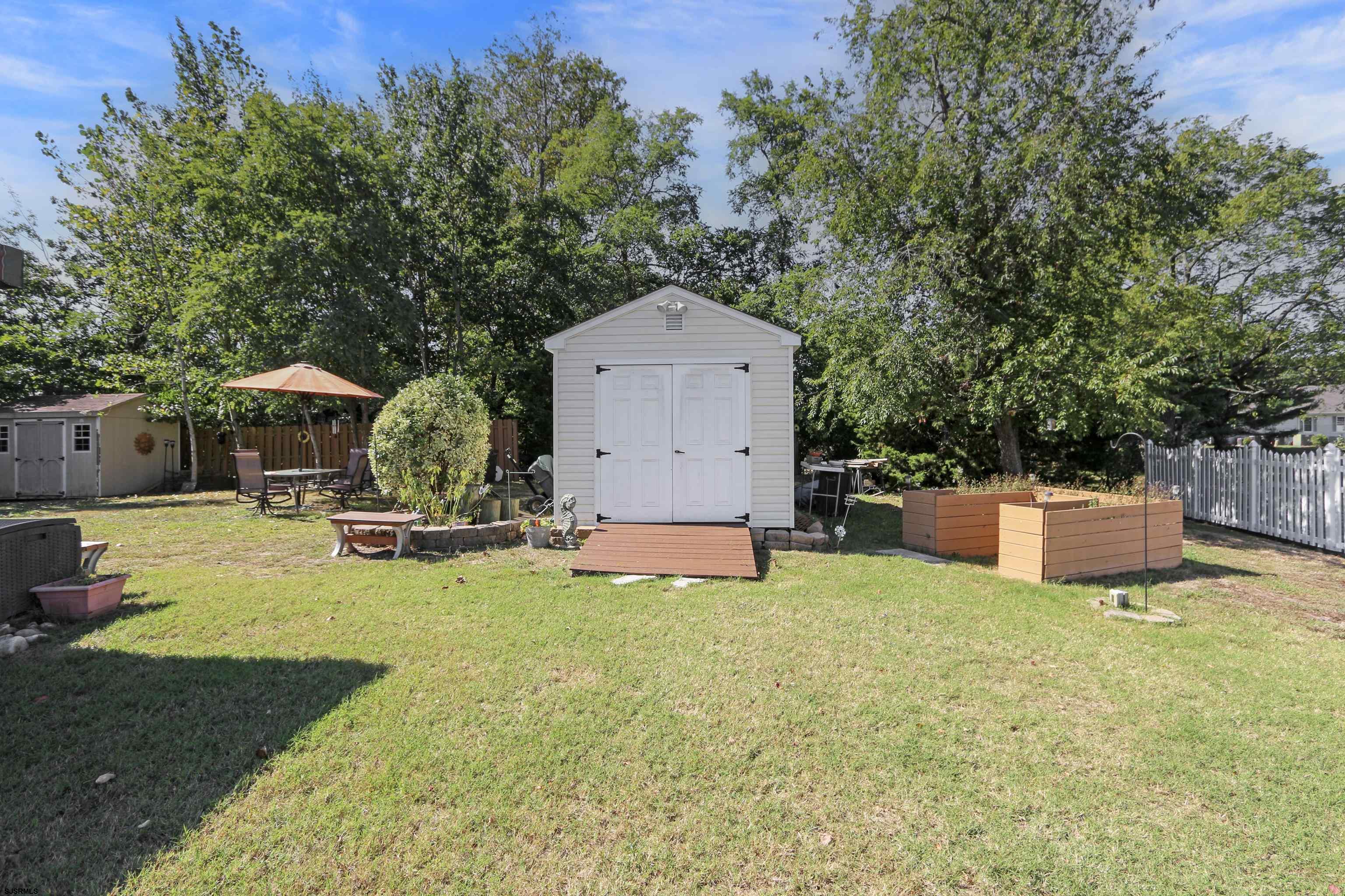 34 North Shore Road Marmora, NJ 08223 - Photo 28 of 37 a swimming pool with outdoor seating and yard