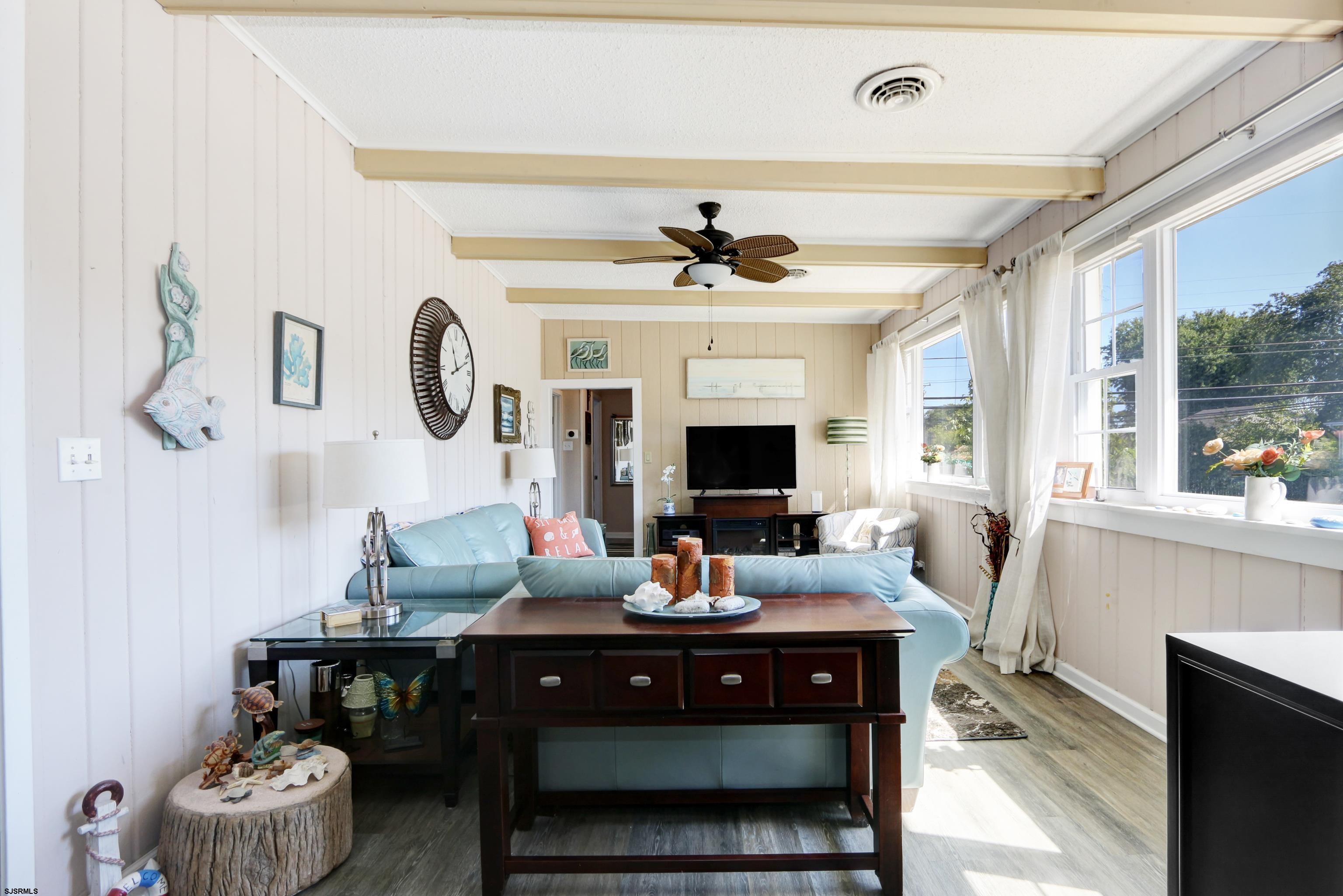 34 North Shore Road Marmora, NJ 08223 - Photo 4 of 37 a living room with furniture and a fireplace