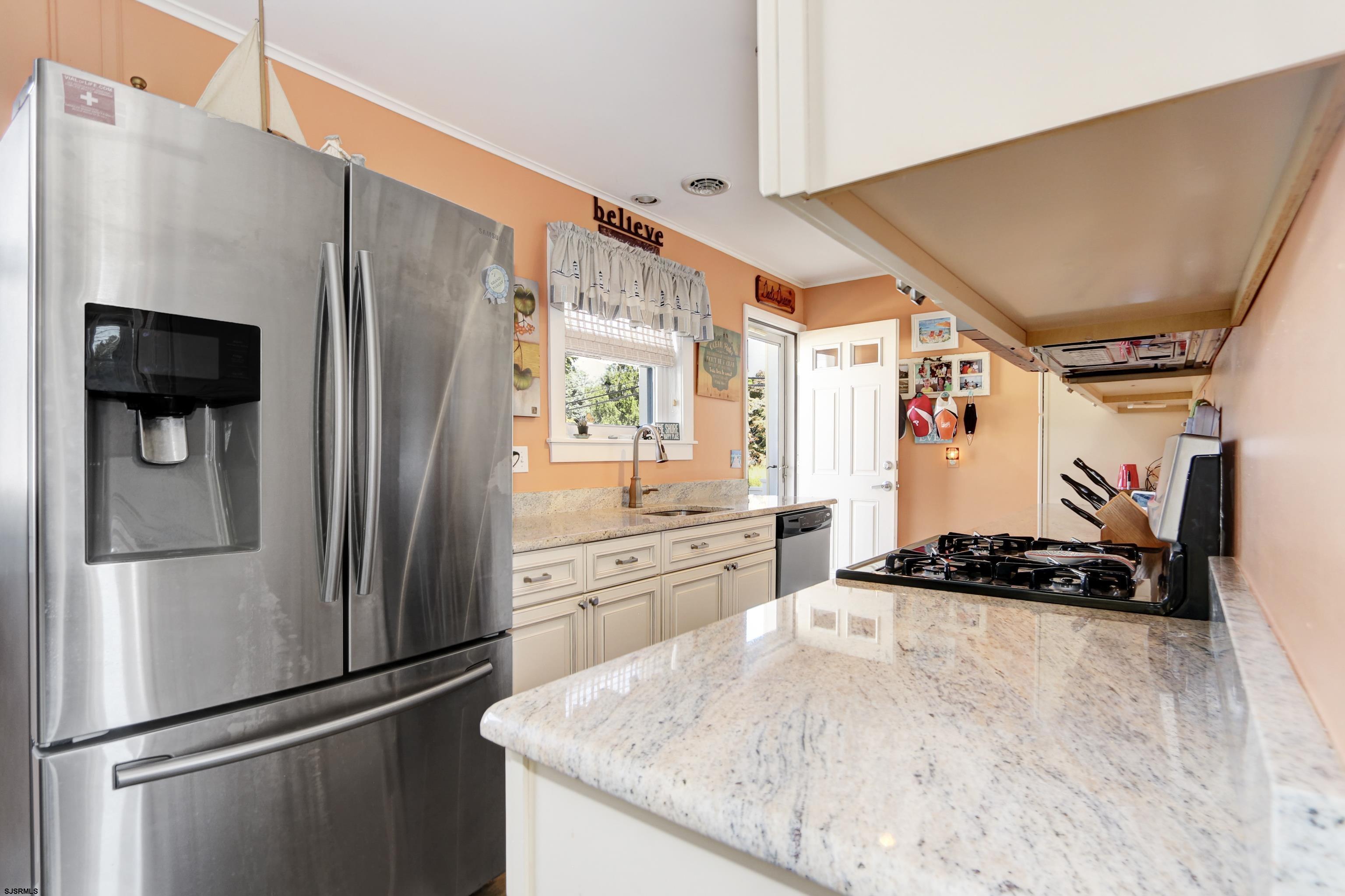 34 North Shore Road Marmora, NJ 08223 - Photo 6 of 37 a kitchen with stainless steel appliances granite countertop a refrigerator and a stove