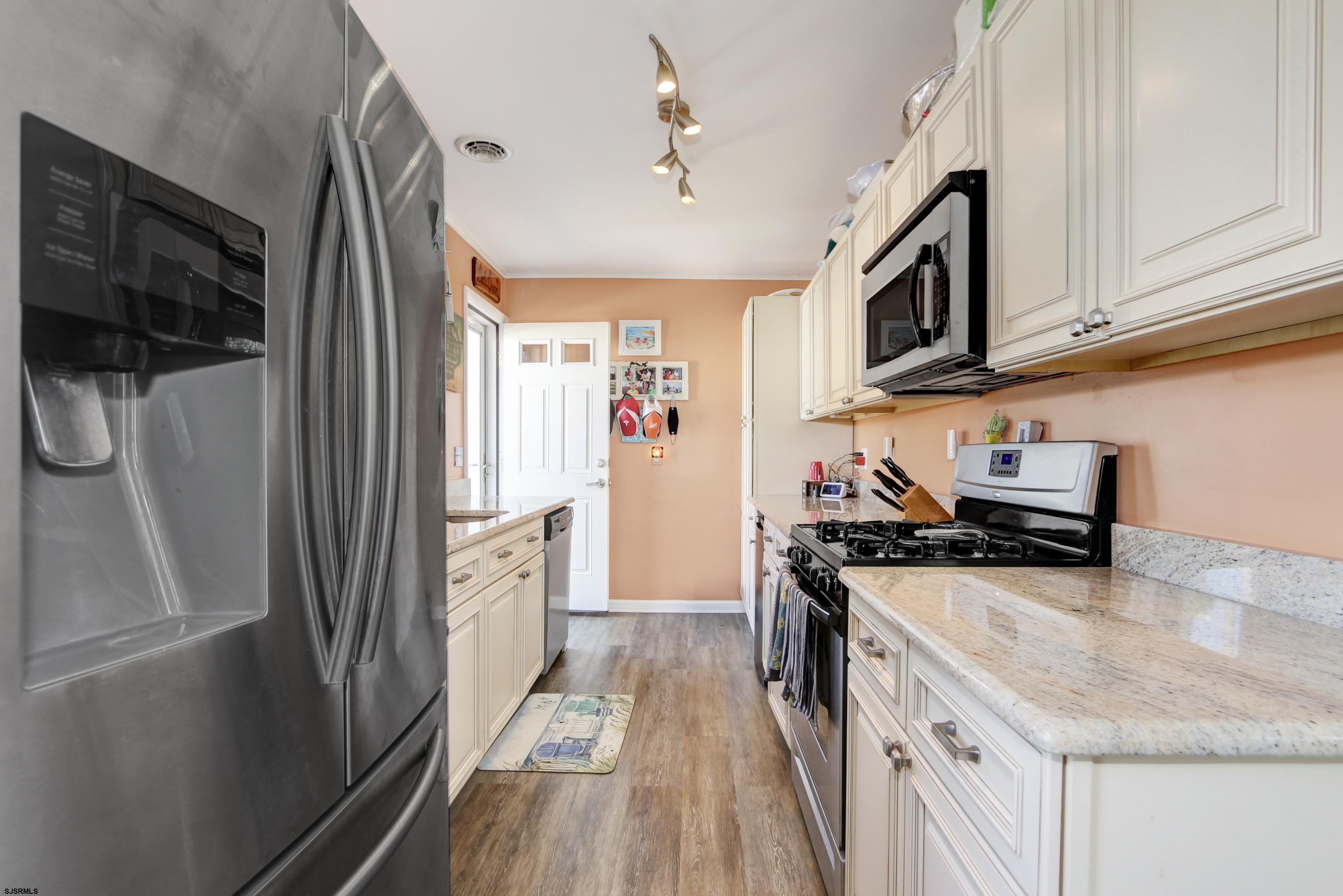 34 North Shore Road Marmora, NJ 08223 - Photo 7 of 37 a kitchen with stainless steel appliances granite countertop a refrigerator a stove and a sink