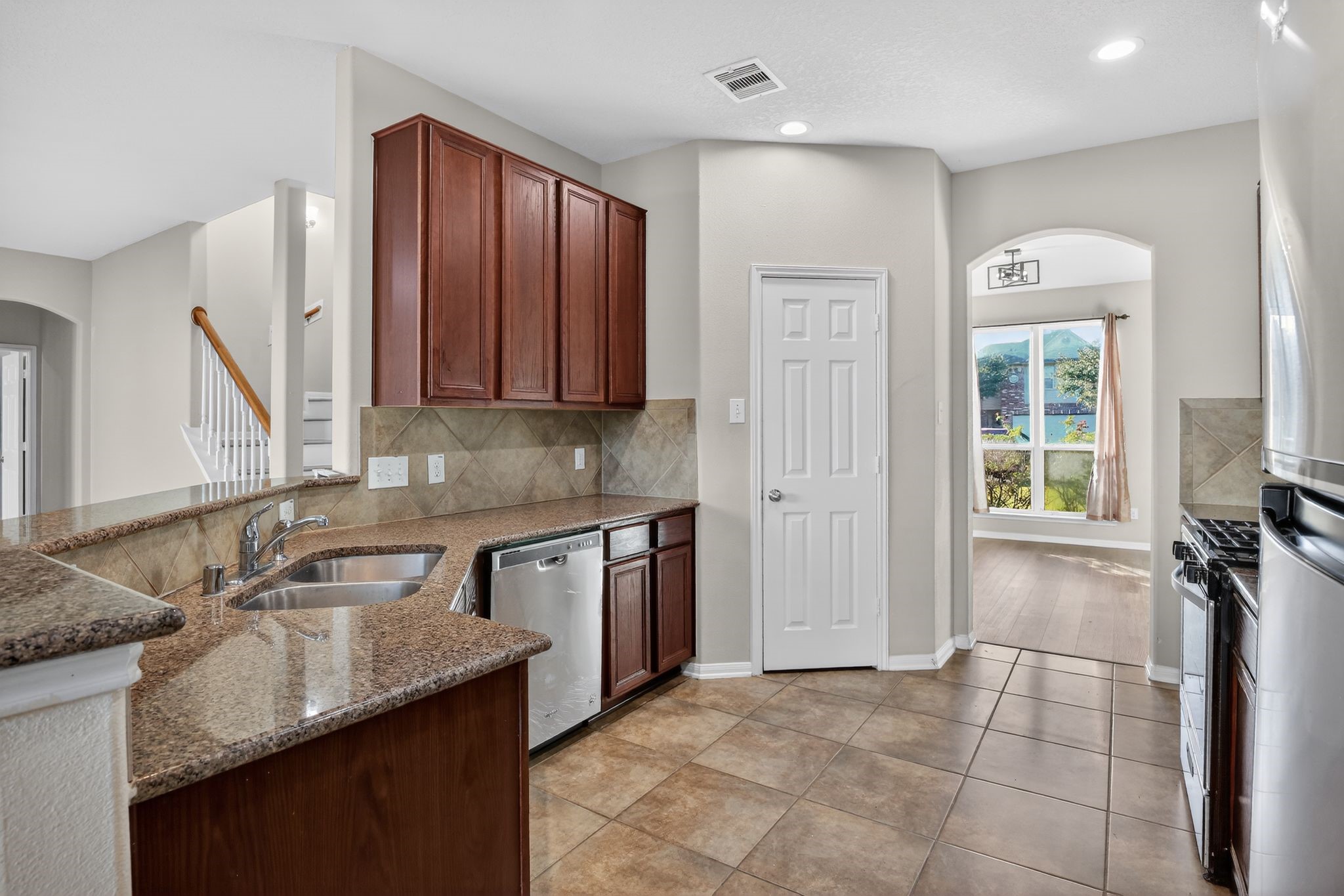 4938 Yearling Ridge Court Katy, TX 77449 - Photo 8 of 29 a kitchen with stainless steel appliances granite countertop a sink stove and cabinets
