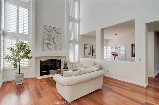 a living room with furniture and a large mirror