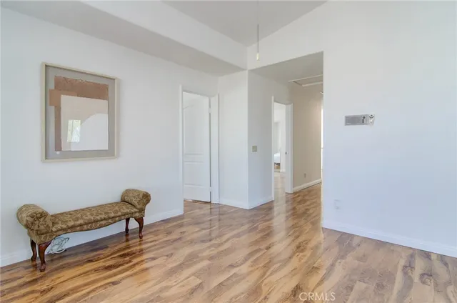 a spacious bedroom with a bed and a chandelier