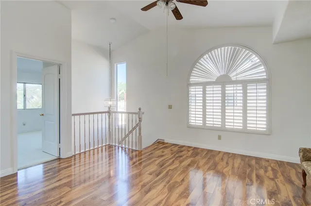 a view of a patio with a table and chairs under an umbrella