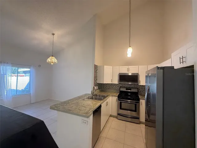 a kitchen with a refrigerator a stove a sink and a refrigerator