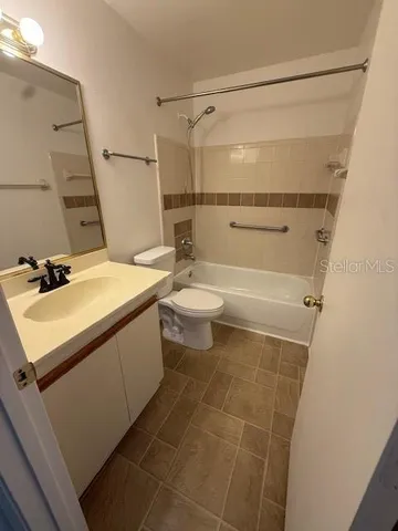 a bathroom with a sink a toilet a mirror and shower