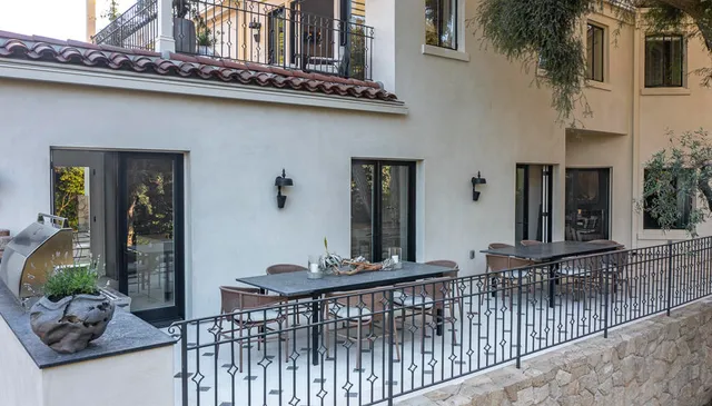 a view of a chairs and table in the balcony