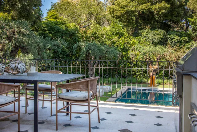 a spacious bedroom with a balcony a bed couch and a large window
