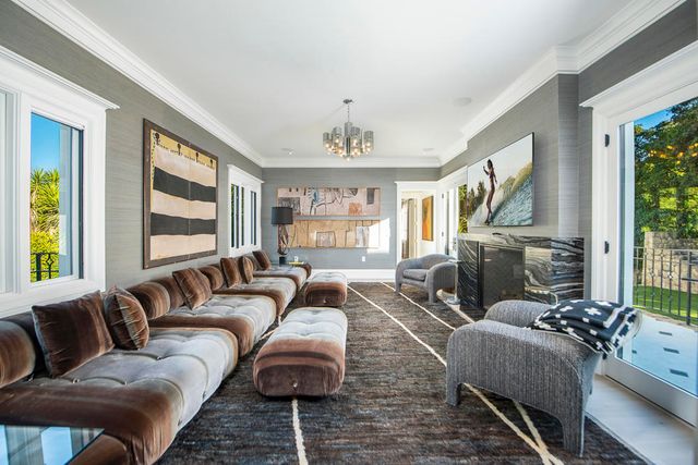 a living room with hard wood floor furniture and a floor to ceiling window
