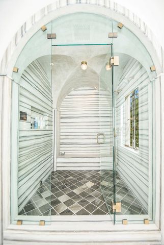 a bathroom with a sink a shower and a mirror