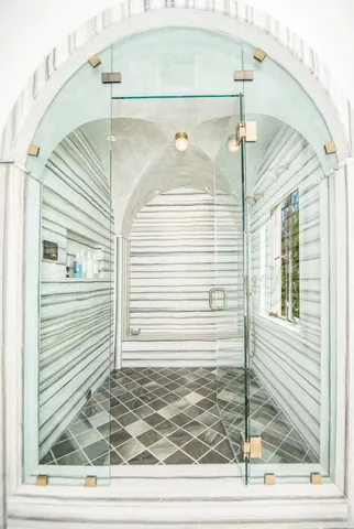 a bathroom with a sink a shower and a mirror