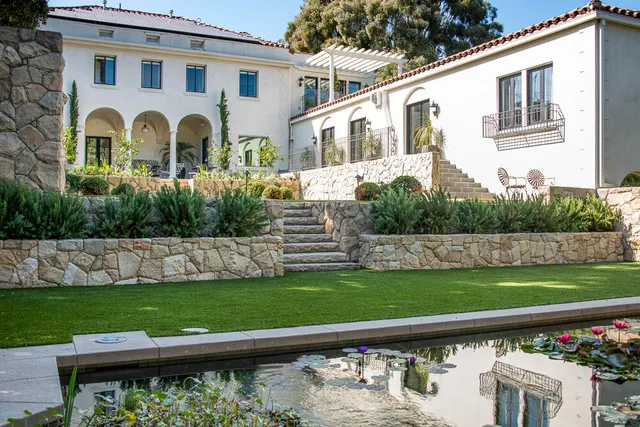 a front view of a house with a garden