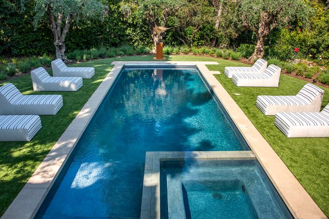 a view of a backyard with couches and fire pit