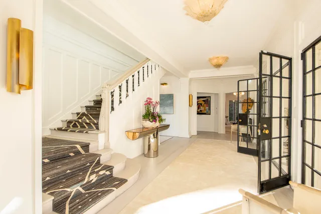 a living room with fireplace furniture and a large window