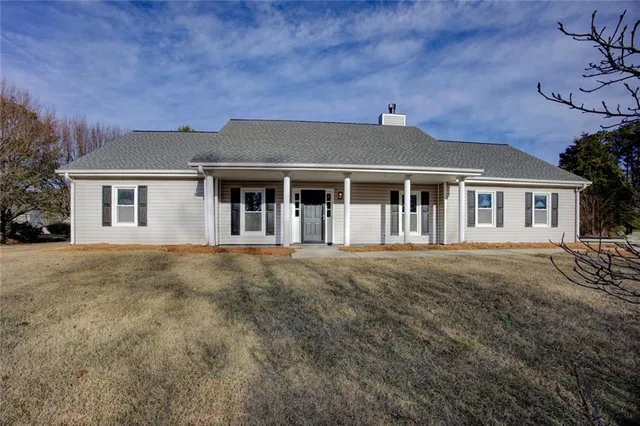 a front view of a house with a garden