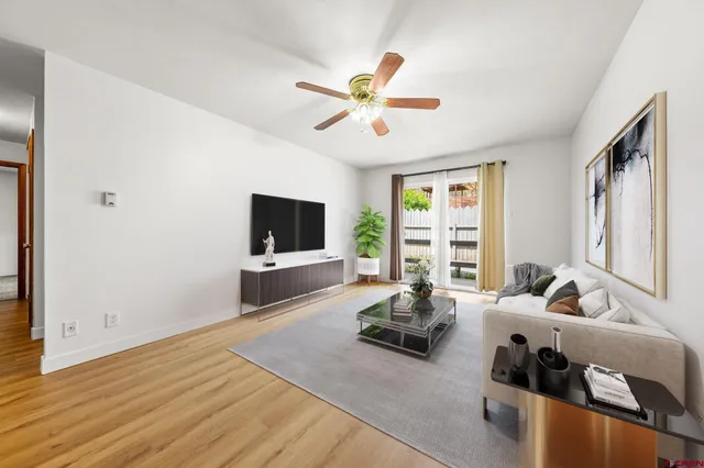 a living room with furniture tv and a window