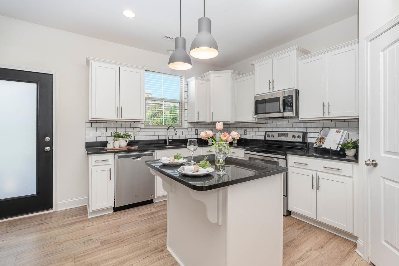 1612 Chestnut Falls Road Wendell, NC 27591 - Photo 7 of 19 Island for Extra Seating AND Functionality! Beautiful UPDATED Lighting & Stainless Steel Appliances! Kitchen
