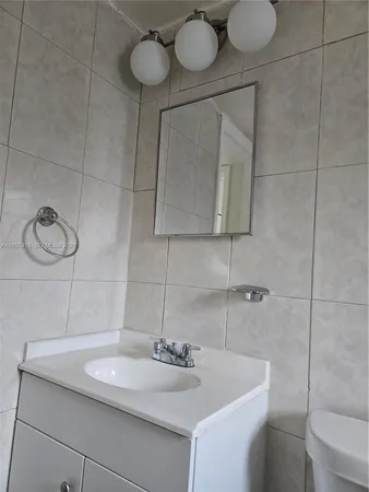 a bathroom with a toilet a sink and bathtub