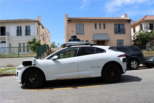 a view of a car parked in front of a house