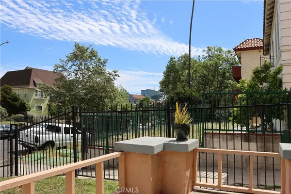 a balcony with trees in front of it