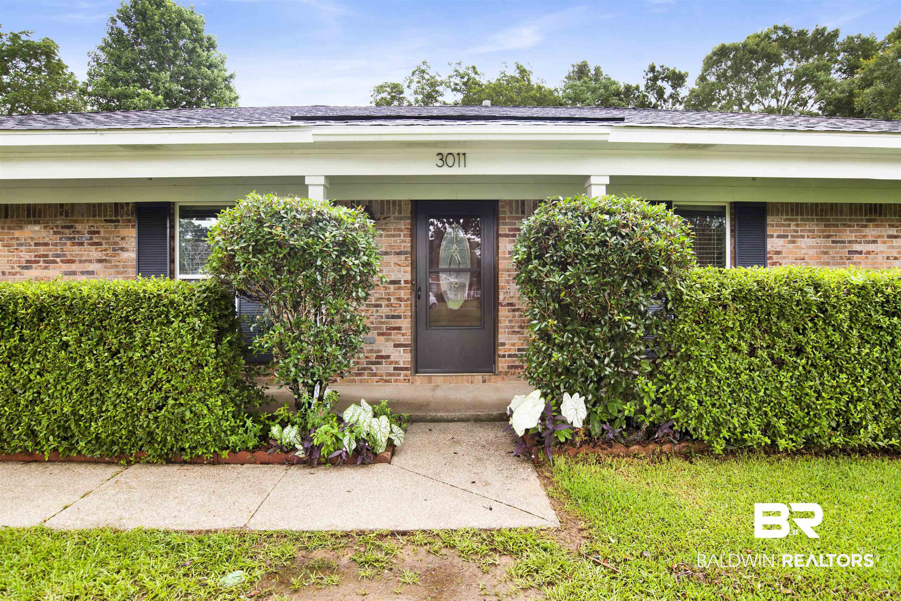 View of exterior entry with brick siding