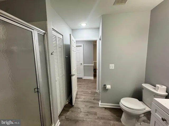 a bathroom with a shower and a toilet