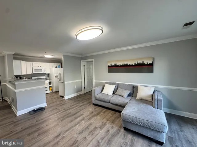 a living room with furniture and kitchen view
