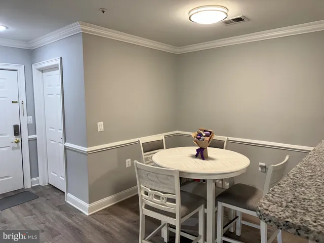 a dining room with furniture and wooden floor